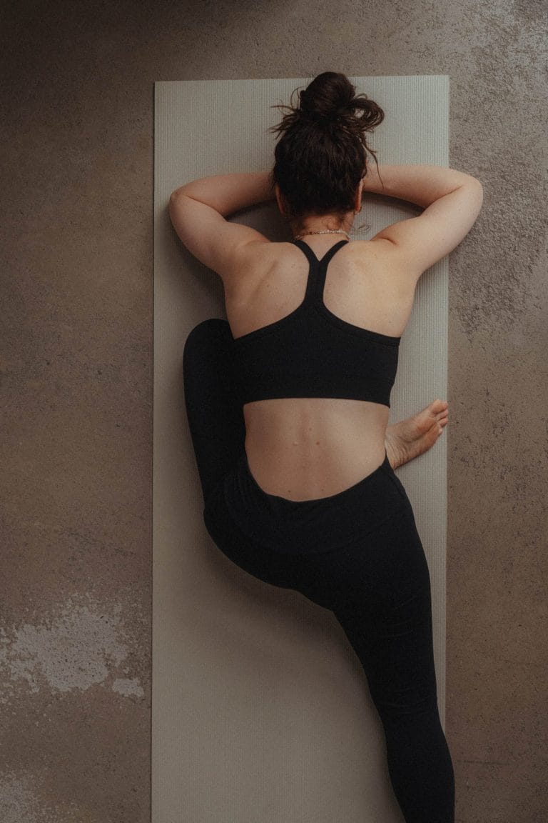 Tiefe Entspannung beim Yin Yoga in Rostock: Yogini praktiziert die schlafende Taube (Eka Pada Rajakapotasana) zur intensiven Hüftöffnung auf der Matte.